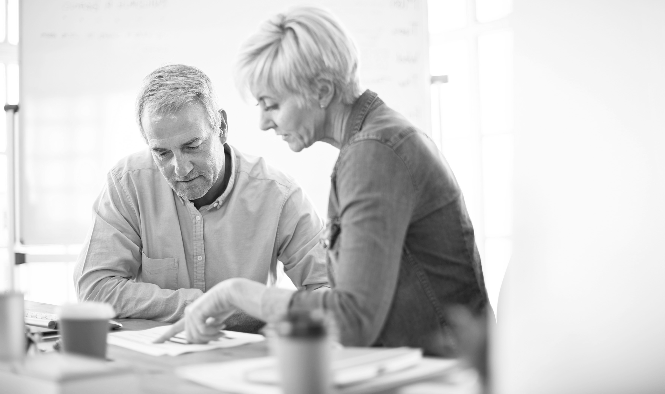 Man and woman discuss finances at table